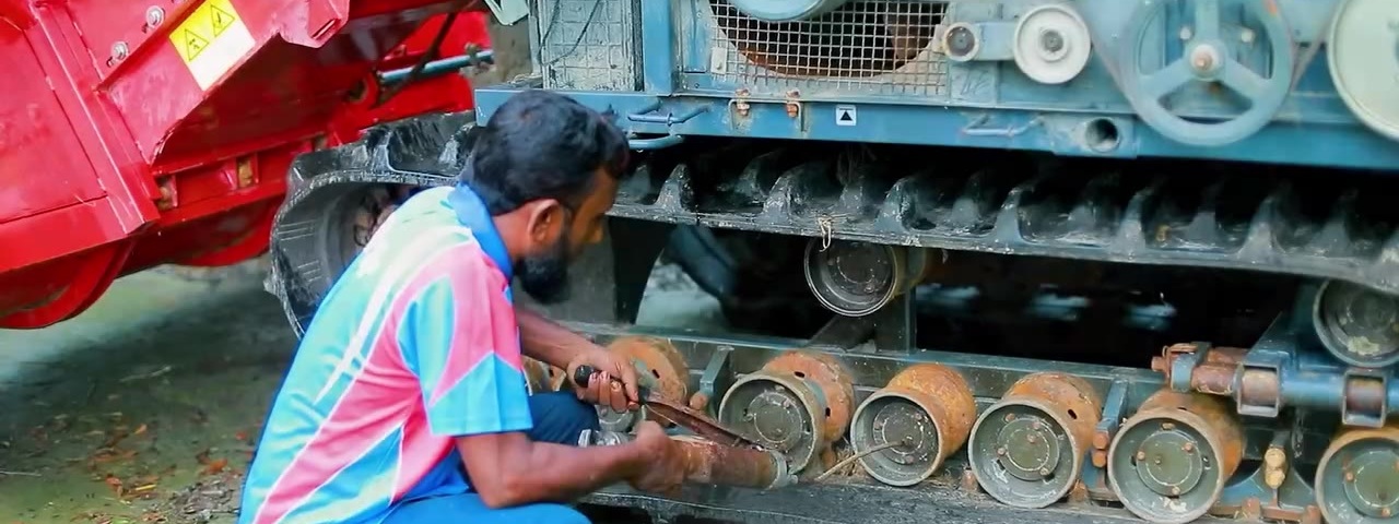 Track inspection is an important part of maintaining combine harvesters operating in muddy paddy fields.